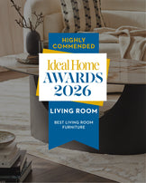 Winslow TV Unit in ceramic natural finish, cylindrical shape, styled in modern living room with decor.