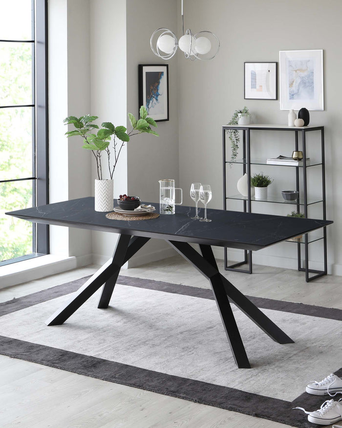 Modern black dining table with a sleek, minimalist design featuring angular, intersecting legs and a matte tabletop. Accompanying the table is a simple, elegant metal shelving unit with five levels for decorative objects and books, finished in a matching black tone to complement the table's contemporary aesthetic. The ensemble is showcased in a well-lit room with large windows, highlighting the furniture's clean lines and modern appeal.