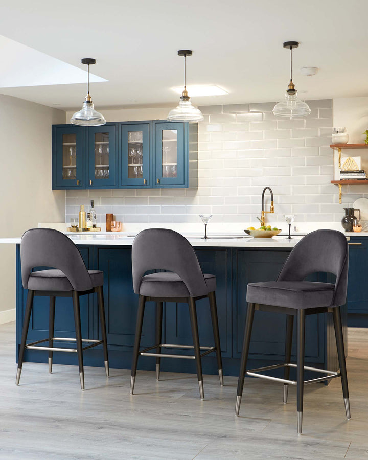 Three modern bar stools with dark grey upholstery and black metal legs, featuring a sleek design with a curved backrest and a metal footrest.