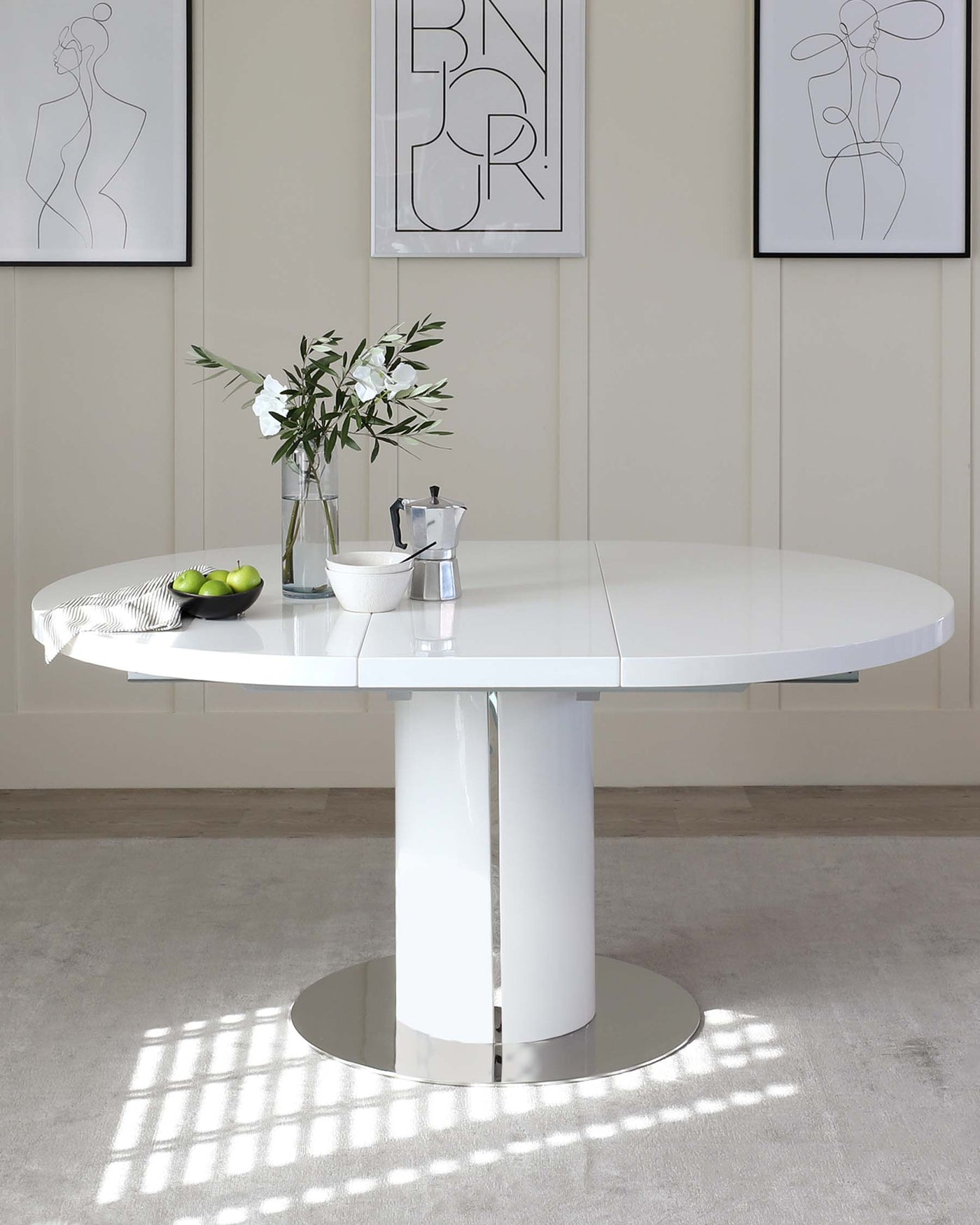 Modern white round dining table with a glossy finish, featuring a central cylindrical pedestal and a circular base.