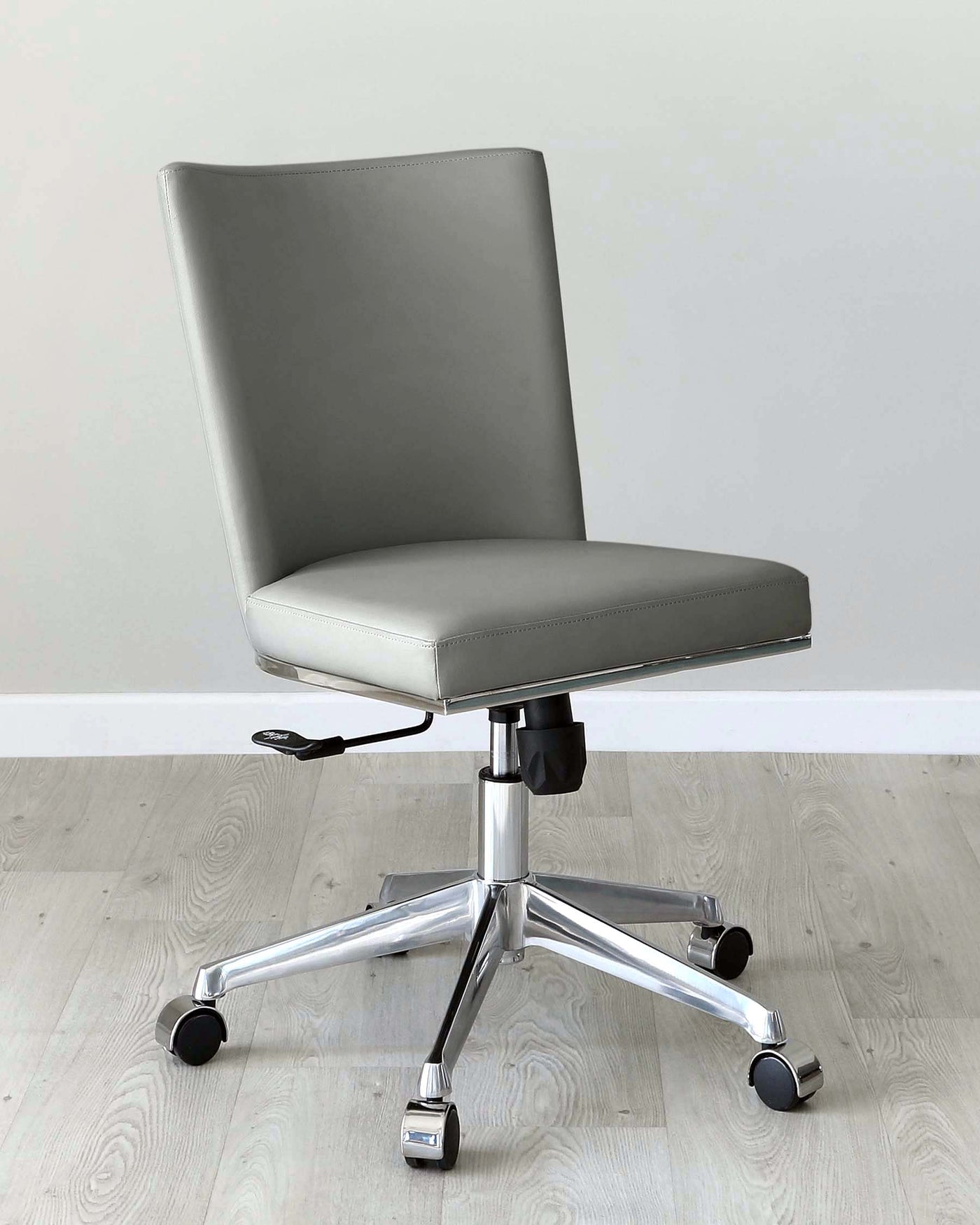 Modern office chair with a high back, upholstered in grey leatherette, featuring a streamlined design, an adjustable height lever, and a five-point chrome base with caster wheels for mobility.