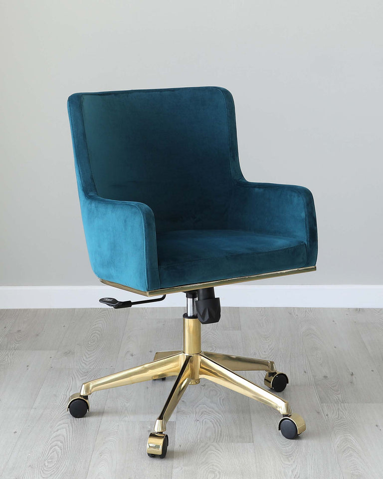 Teal blue velvet office chair with a high backrest and armrests, featuring an adjustable height mechanism, a swivel base, and five gold-coloured metal legs with caster wheels.