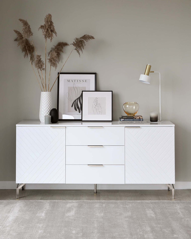 Modern white sideboard featuring a geometric patterned facade with a mix of hinged and sliding doors, complemented by sleek metallic handles and supported by minimalist metallic legs.