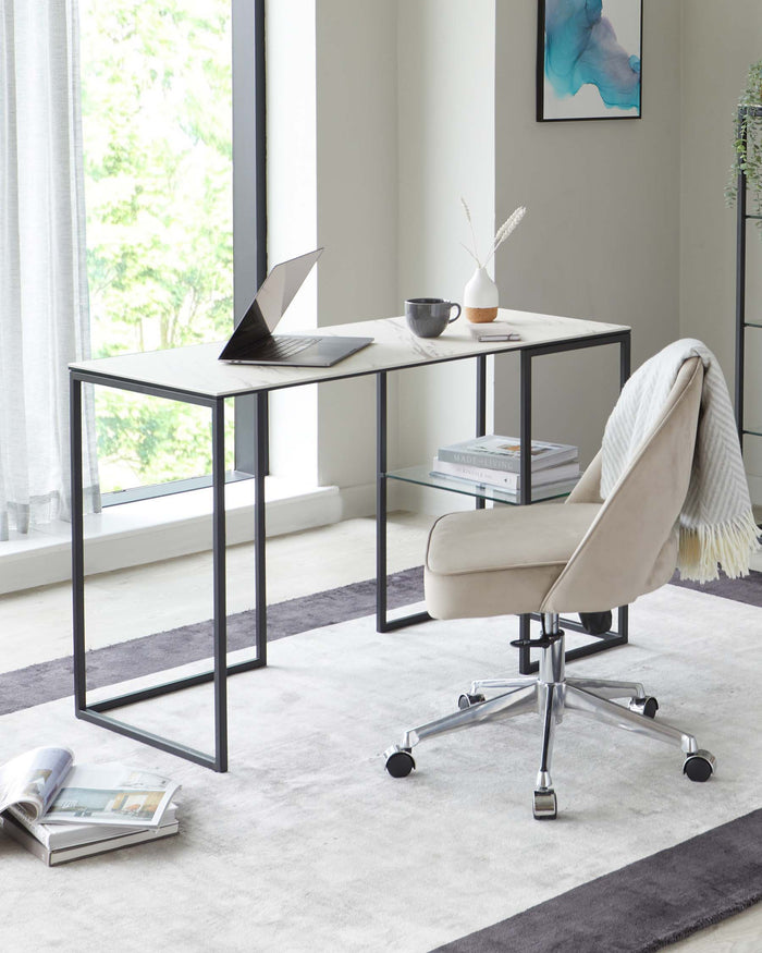 Modern minimalist work desk with a sleek metal frame and a light wood finish top, paired with a contemporary light beige upholstered office chair on a five-star chrome base with casters. The setting is complemented by a light grey area rug underneath.