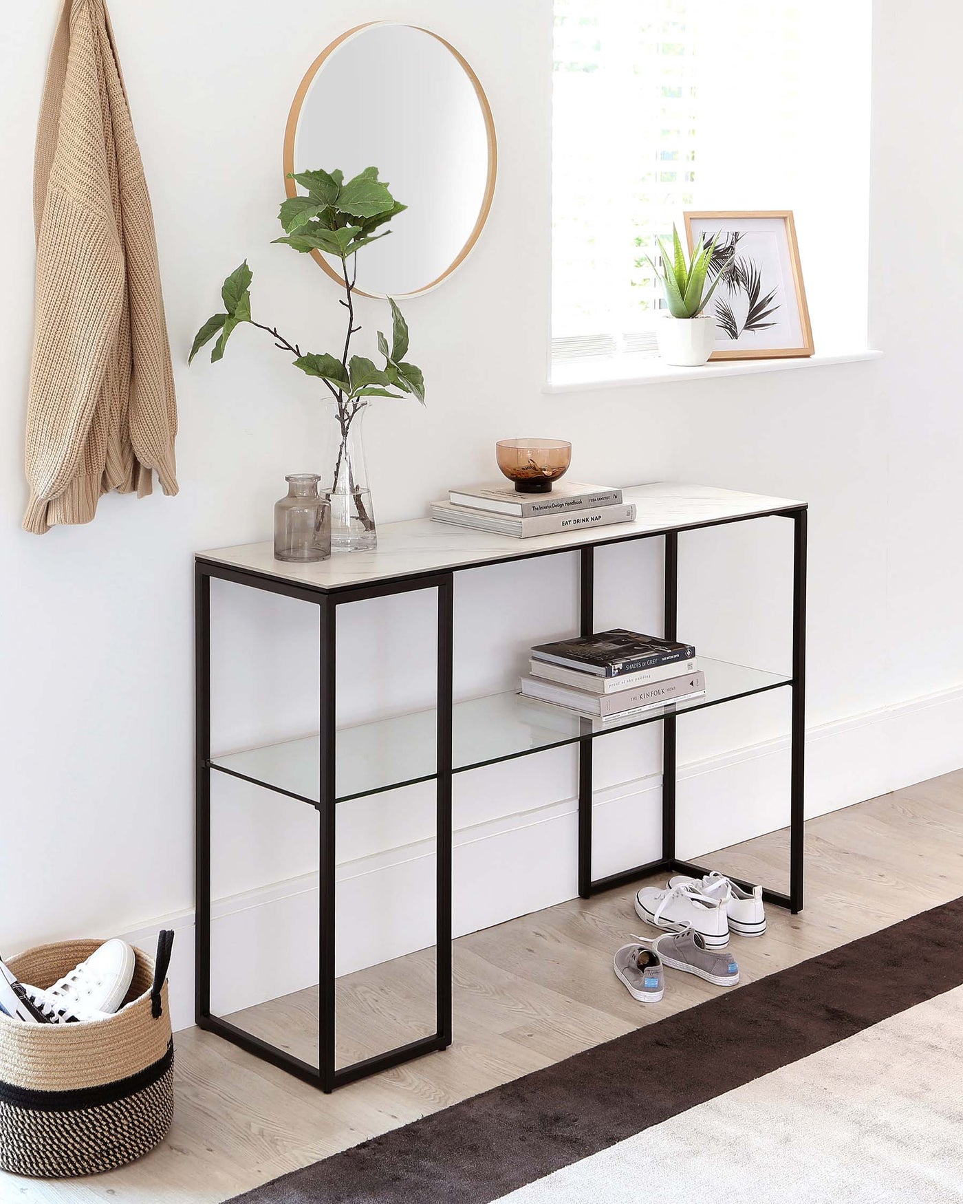 Modern minimalist console table with a white marble effect top and sleek black metal frame, featuring two rectangular tiers for additional storage or display, ideal for contemporary interiors.