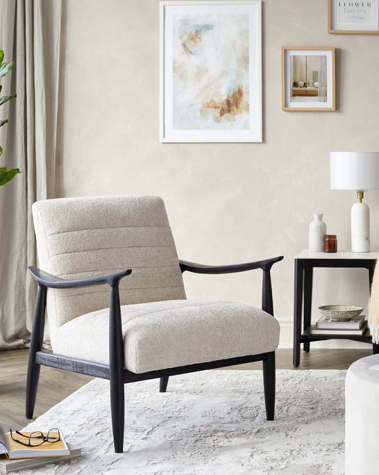 Elegant accent chair with a textured beige upholstery and a sleek dark wooden frame, featuring curved armrests and a comfortably angled backrest, placed on a white patterned area rug.