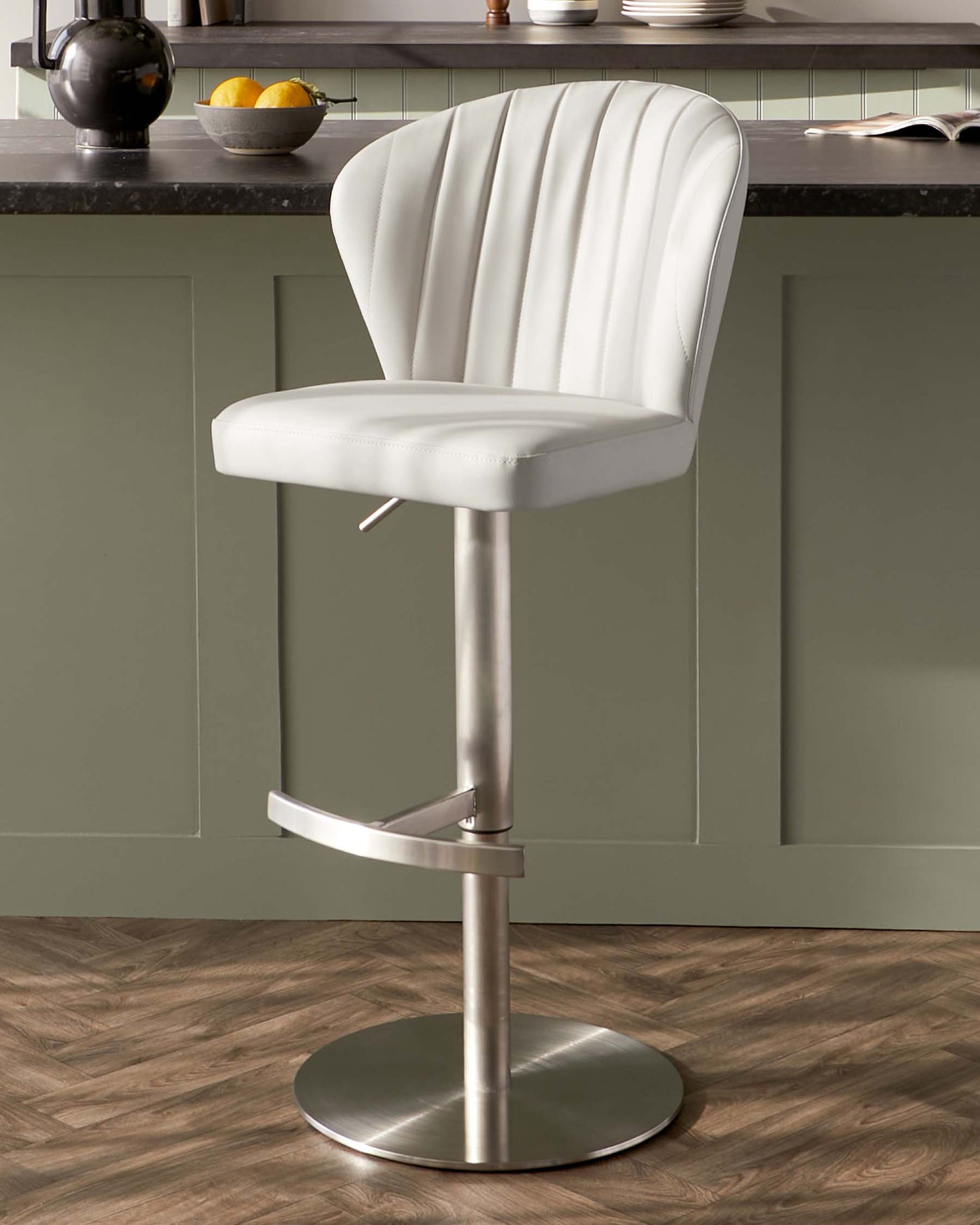 Modern adjustable bar stool with a high back, white faux leather upholstery, vertical stitching detail, supported by a chrome pedestal base with a built-in footrest.