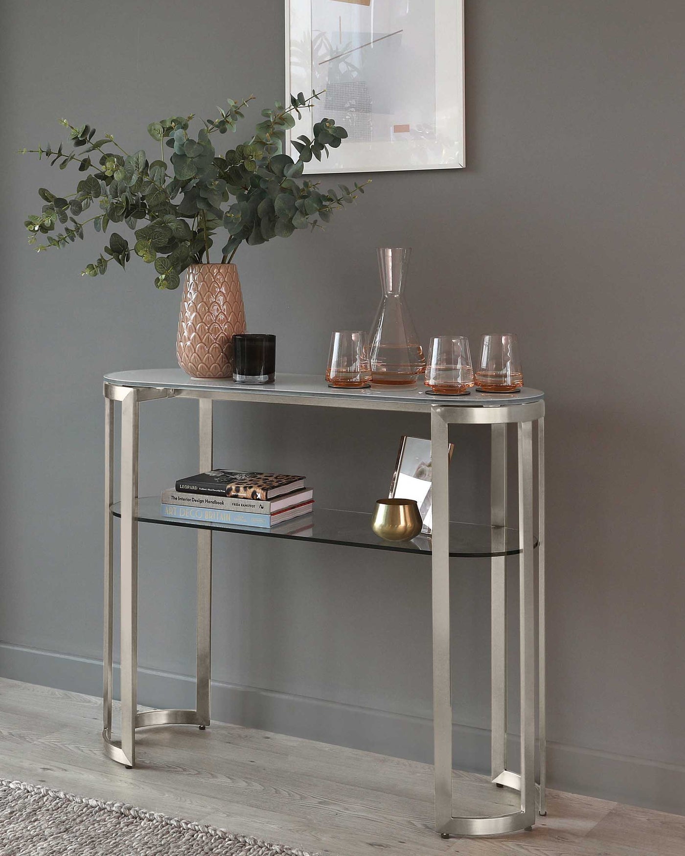 Elegant semi-circular silver console table with a mirrored top surface and a lower glass shelf, featuring slender metal frame and legs.