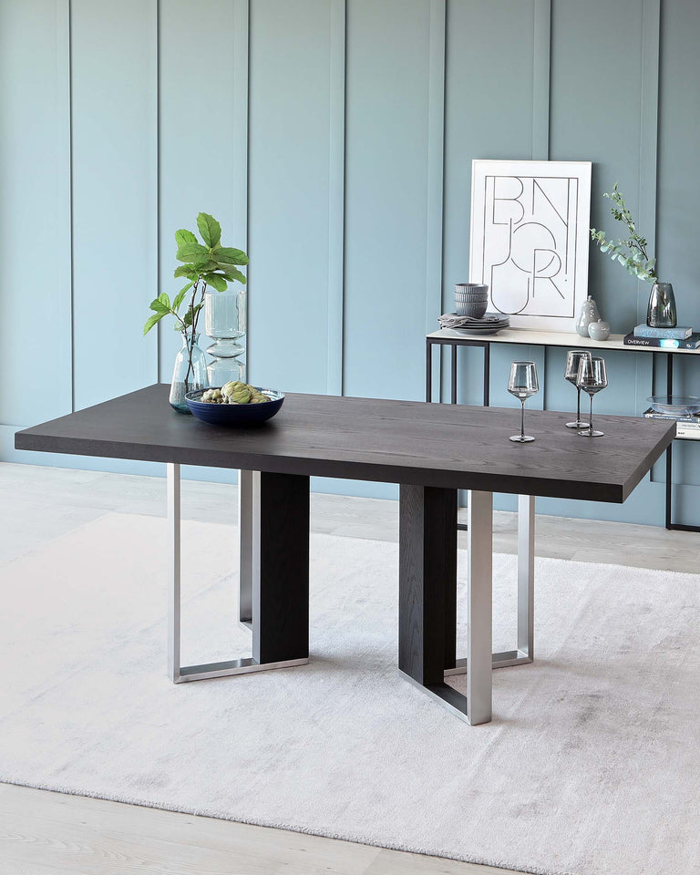 Modern rectangular dining table with a dark wood top and contrasting metal legs, displayed in a contemporary room setting with coordinating decor.