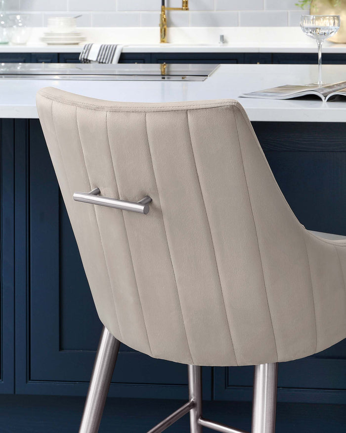 Modern light beige upholstered bar stool with a high back and channel stitching, featuring a sleek chrome base and footrest.