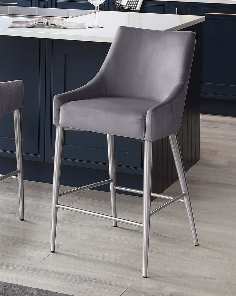Modern grey upholstered bar stool with backrest and armrests, featuring sleek metallic legs and support rungs.
