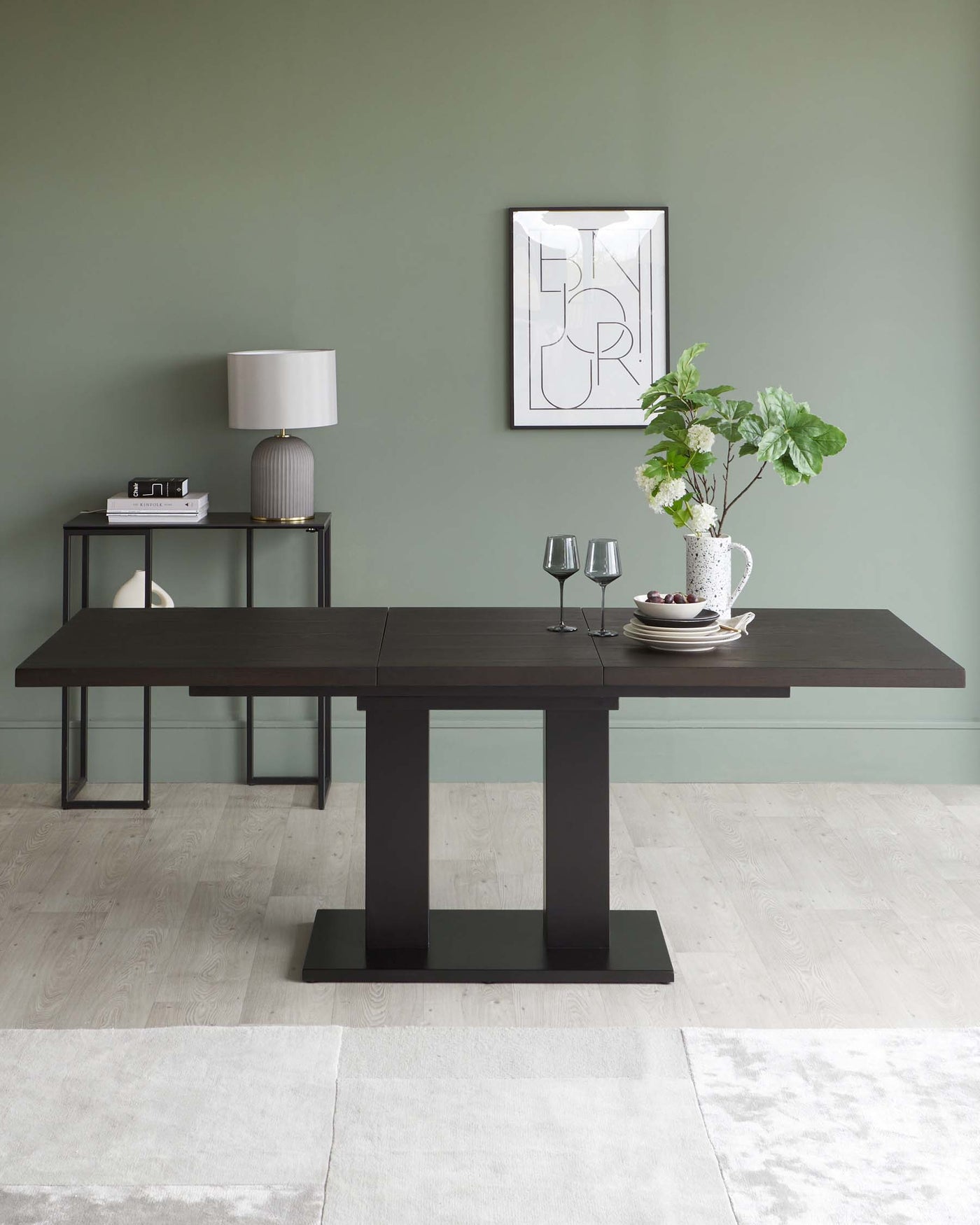 Modern minimalist furniture set in a contemporary dining room, featuring a dark wooden table with a robust rectangular top and block legs, complemented by a matching slender console table with metal frame legs. Both pieces showcase clean lines and a sleek silhouette.