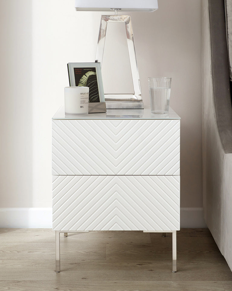 White modern chevron-patterned two-drawer nightstand with metal handles and legs.