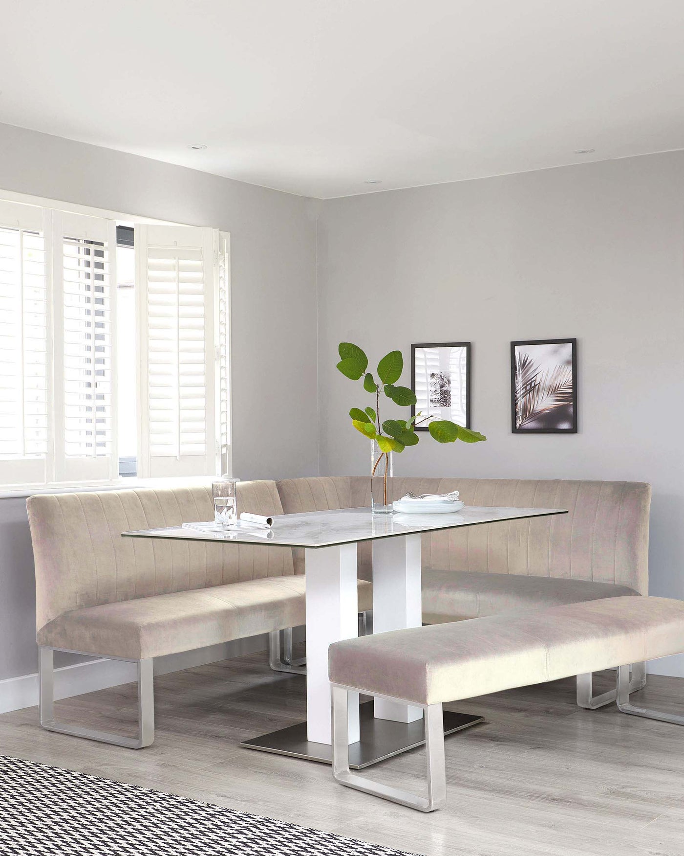 Modern dining set featuring a rectangular marble top table with a white and silver base, accompanied by a matching beige upholstered corner bench with a backrest and a coordinating dining bench without a backrest.