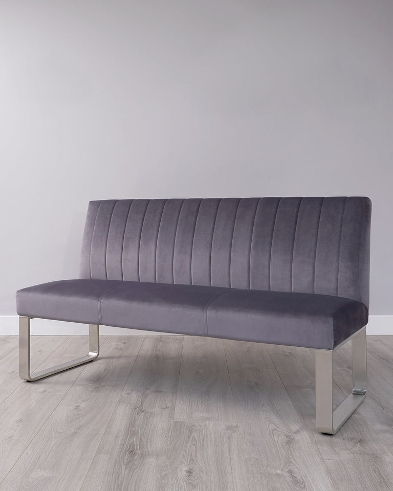 Modern grey upholstered bench with vertical channel tufting and sleek metallic legs.