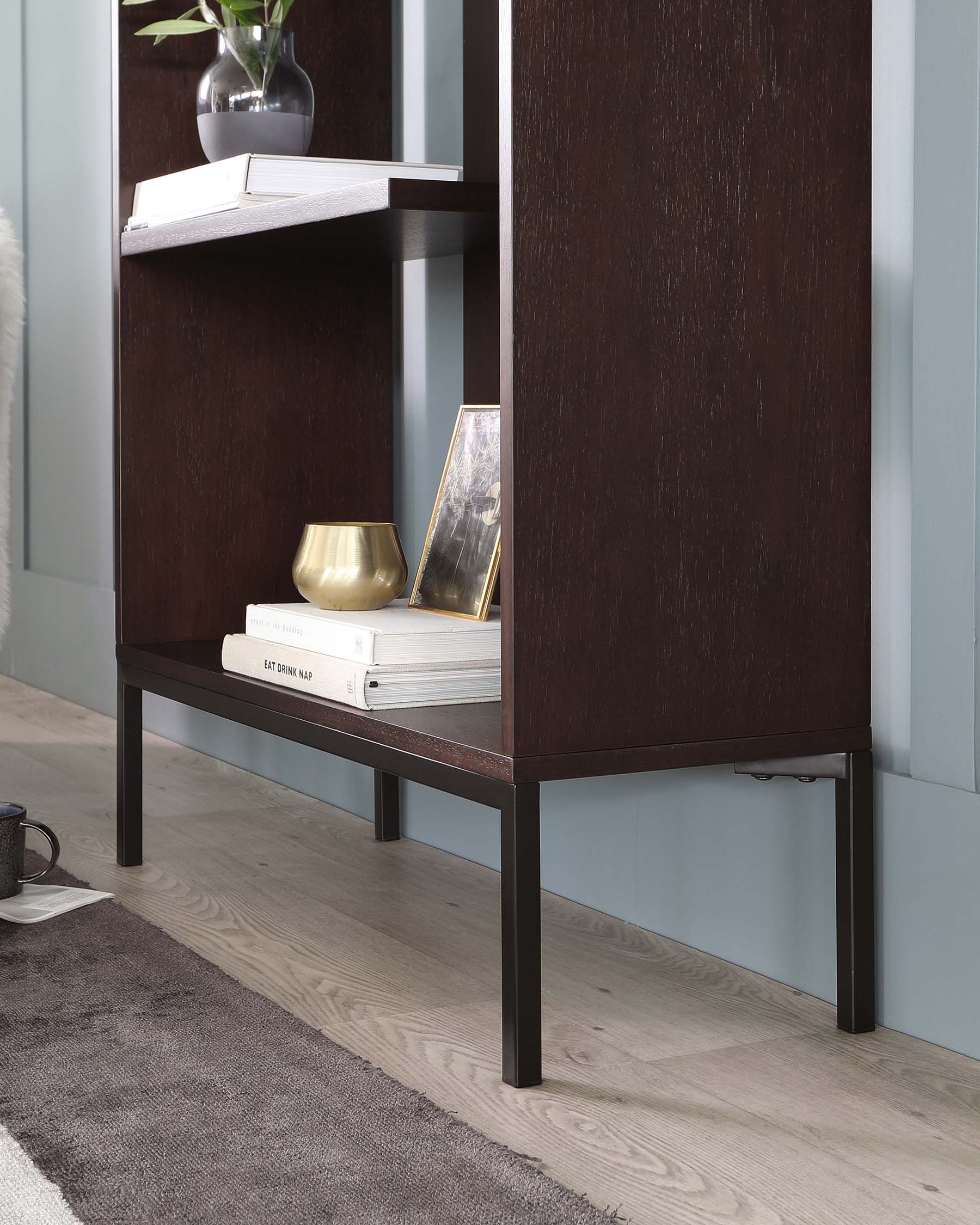 A contemporary espresso-finished console table with a rectangular top and a slim shelf below, supported by sleek black metal legs. The minimalist design highlights clean lines and a functional aesthetic.