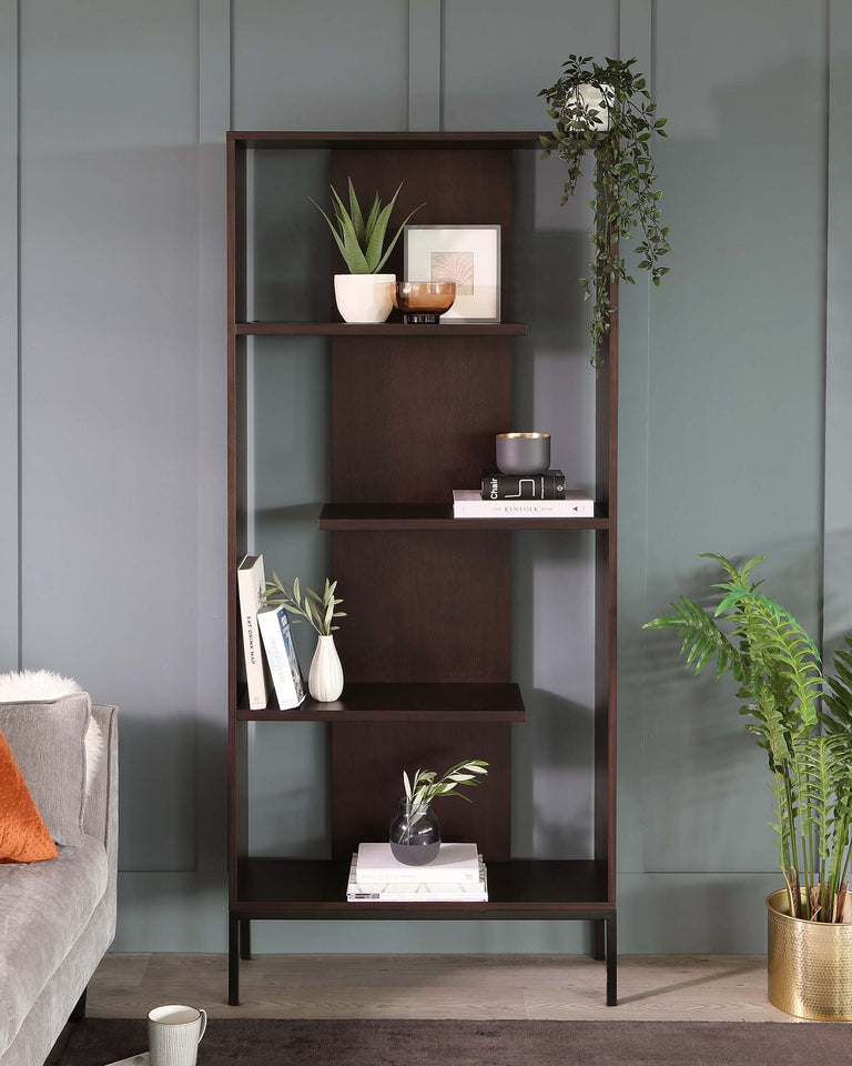 Five-tiered, dark wood and metal bookshelf with asymmetrical shelves, styled with books, decorative plants, and vases.