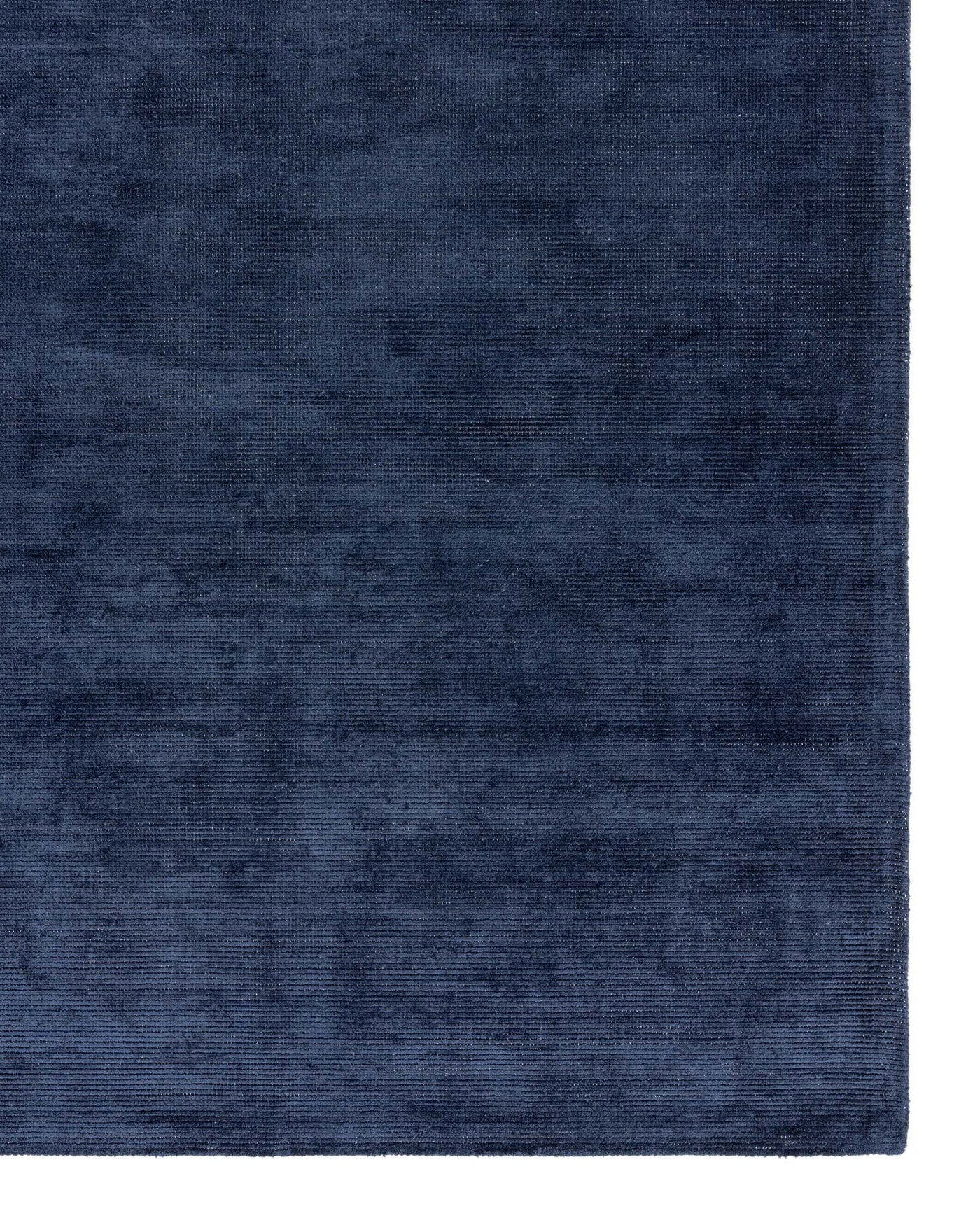 Luxurious navy blue area rug with a subtle woven texture, adding depth and sophistication to any room decor.