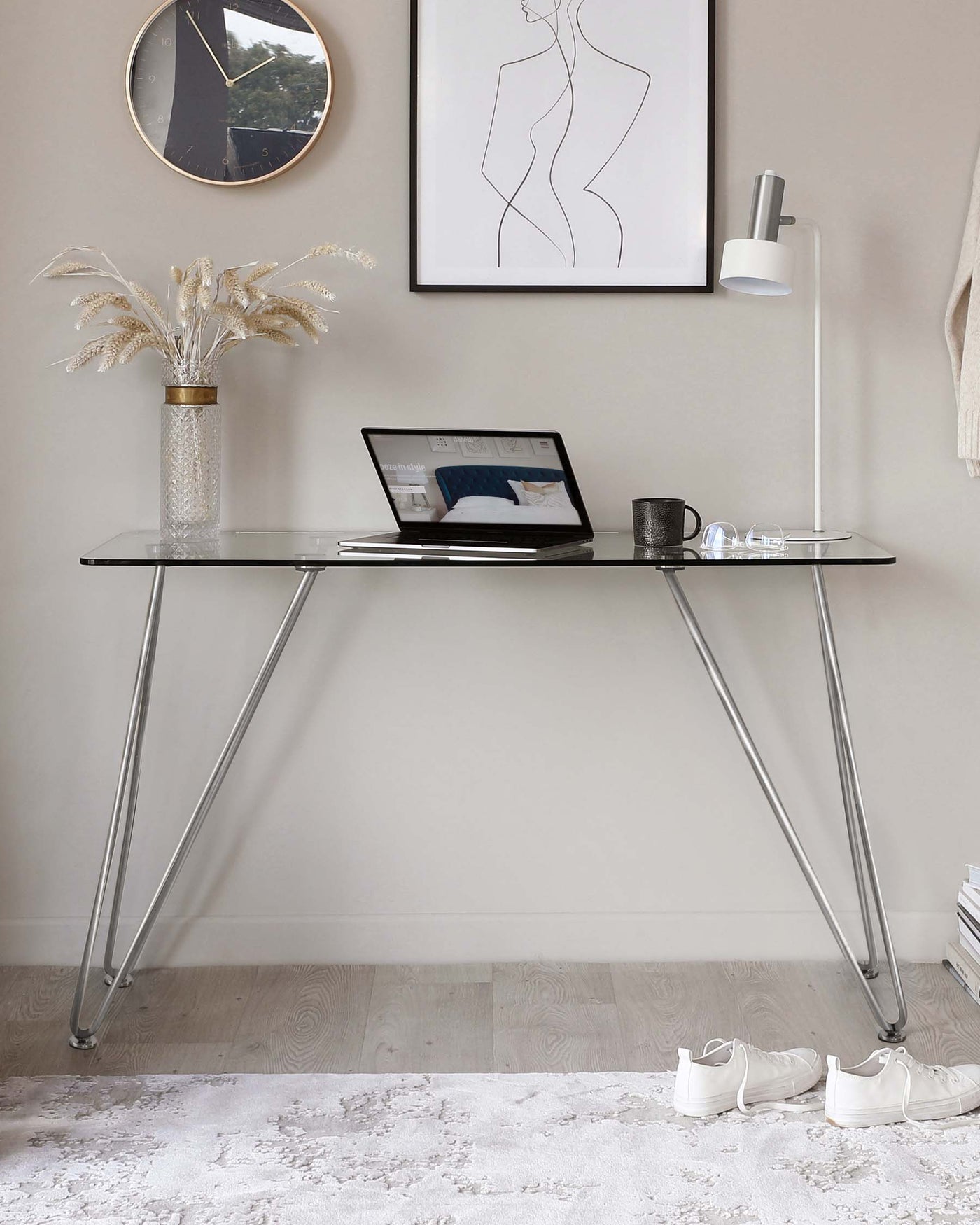 Minimalist modern glass-top desk with sleek, angled chrome legs.
