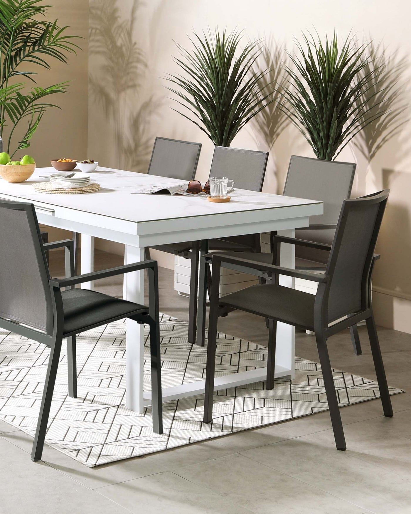 Modern dining set featuring a rectangular white table with a clean, minimalistic design and black metal legs. Accompanied by four contemporary chairs with black frames and grey fabric seat and backrest, complementing the table's sleek aesthetic. Ideal for a sophisticated and stylish dining room.