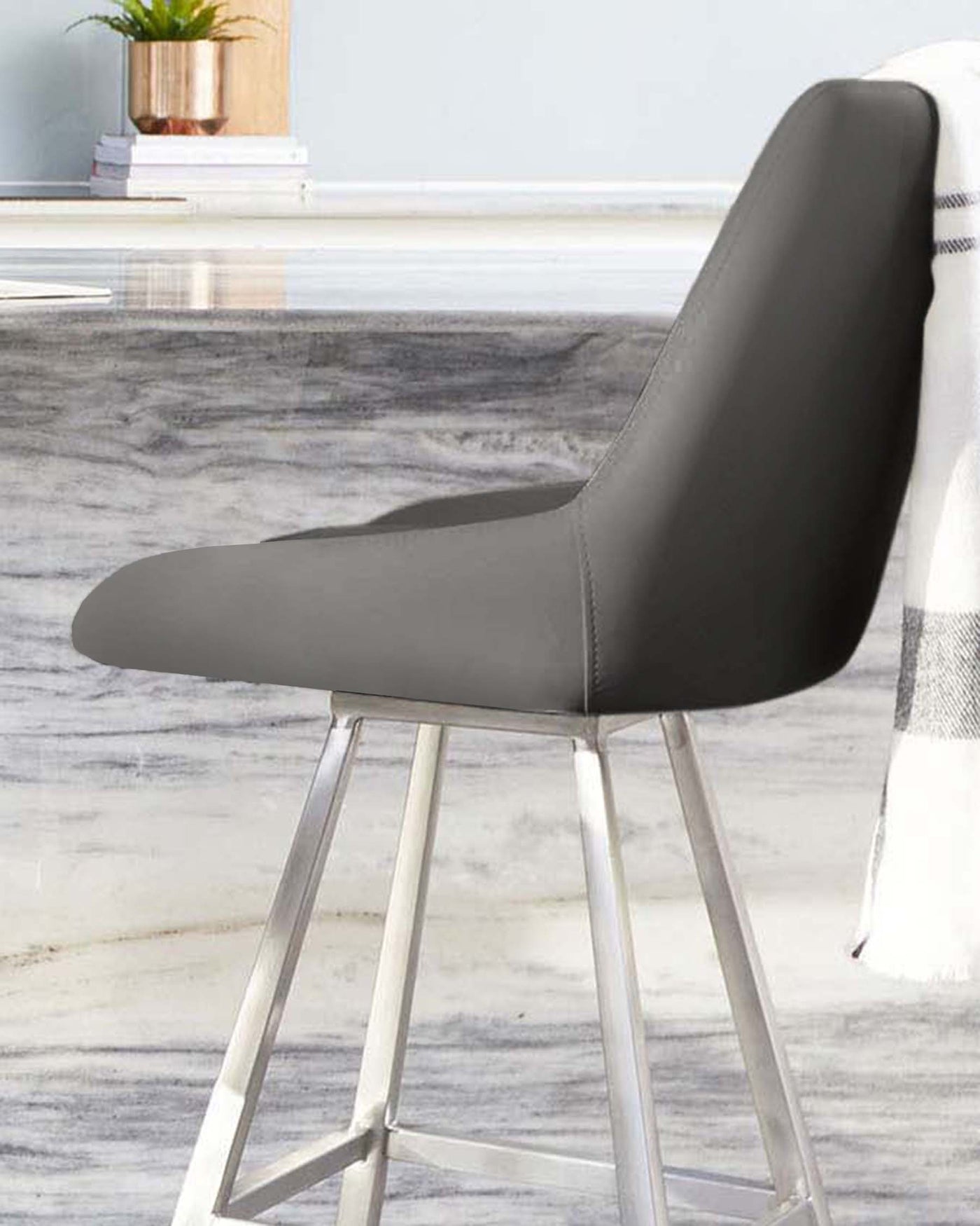 Modern grey upholstered bar stool with sleek metal legs.