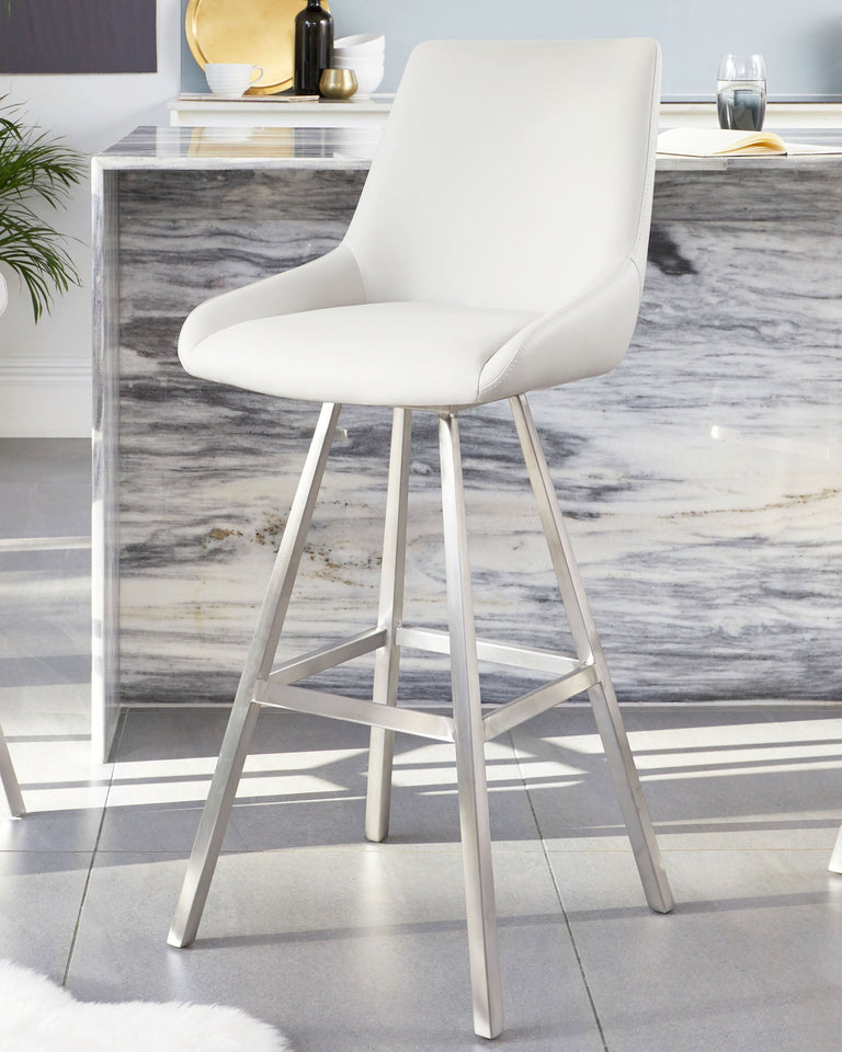 Modern white faux leather upholstered barstool with a sleek high back and brushed stainless steel legs, in front of a marble-top bar console.